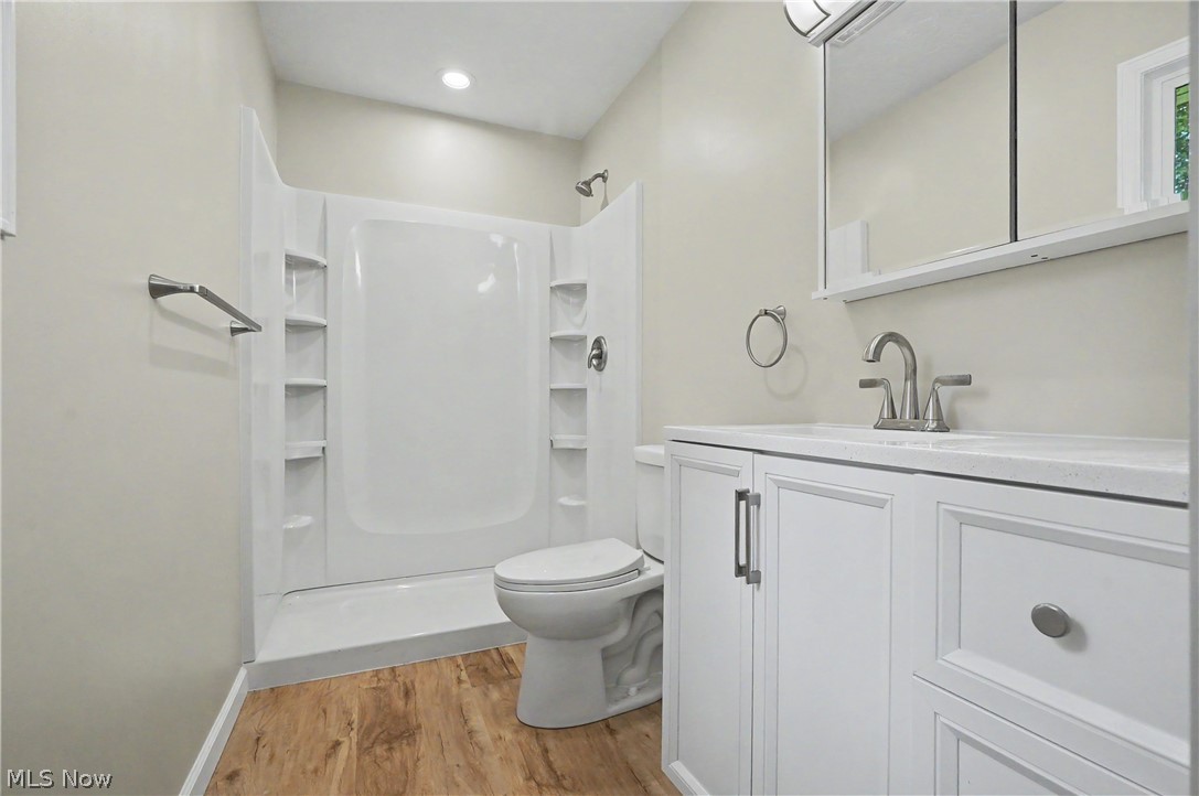 7583 Yale Road Atwater, OH 44201 - Photo 27 of 41 Brand new first floor primary bathroom. Bathroom features upgraded vanity, dual flush toilet, flooring, and bathroom fixtures.