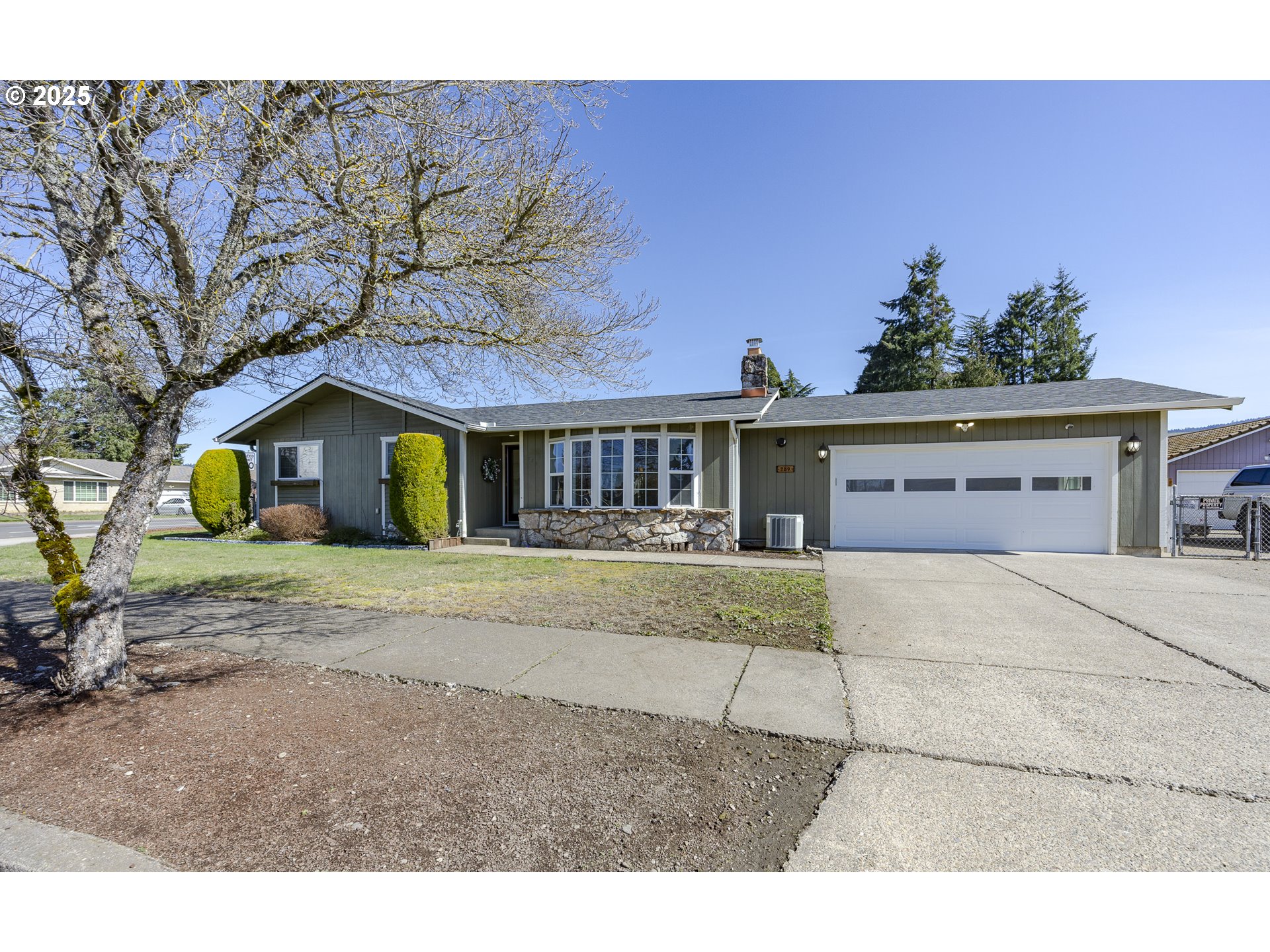 789 66th Street Springfield, OR 97478 - Photo 1 of 37 a front view of a house with a yard and garage