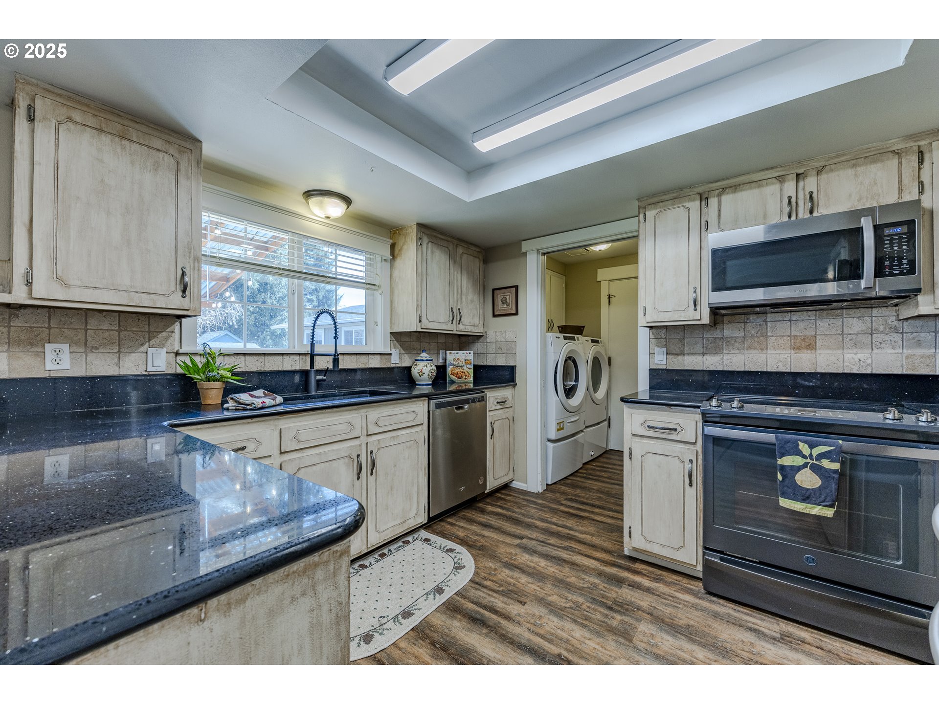 789 66th Street Springfield, OR 97478 - Photo 3 of 37 a kitchen with stainless steel appliances granite countertop a stove a sink and a microwave