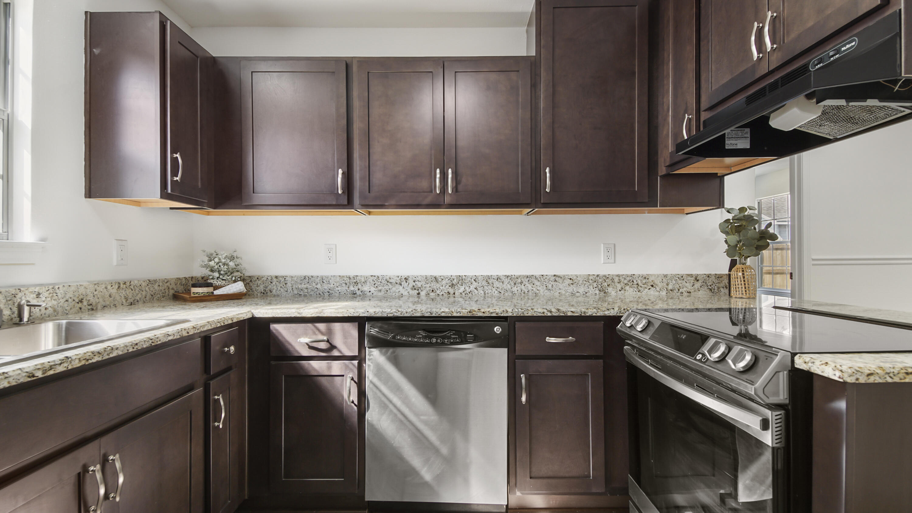 44 Ruby Circle Mary Esther, FL 32569 - Photo 11 of 34 a kitchen with a sink stove and cabinets
