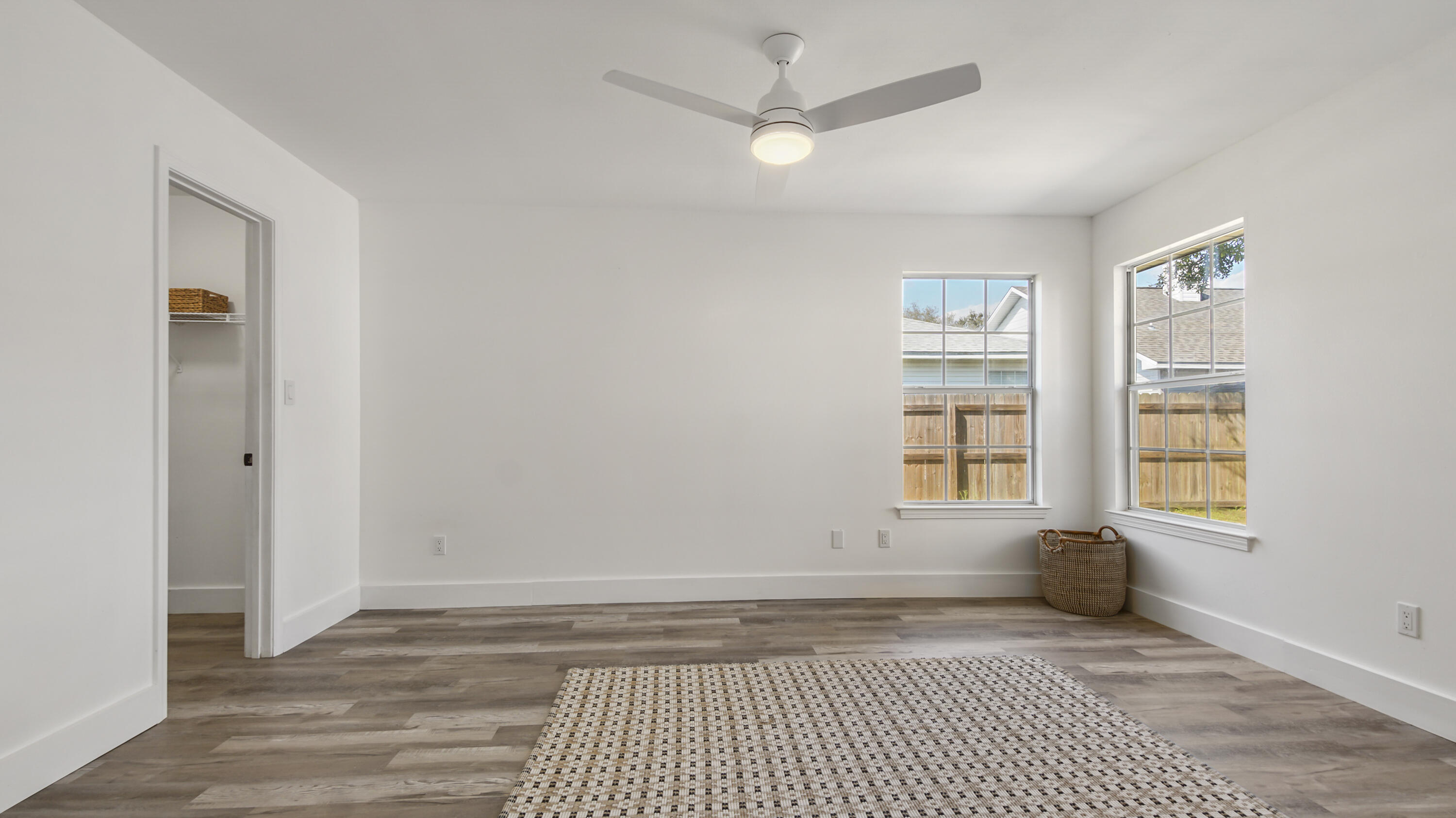44 Ruby Circle Mary Esther, FL 32569 - Photo 16 of 34 an empty room with wooden floor and windows