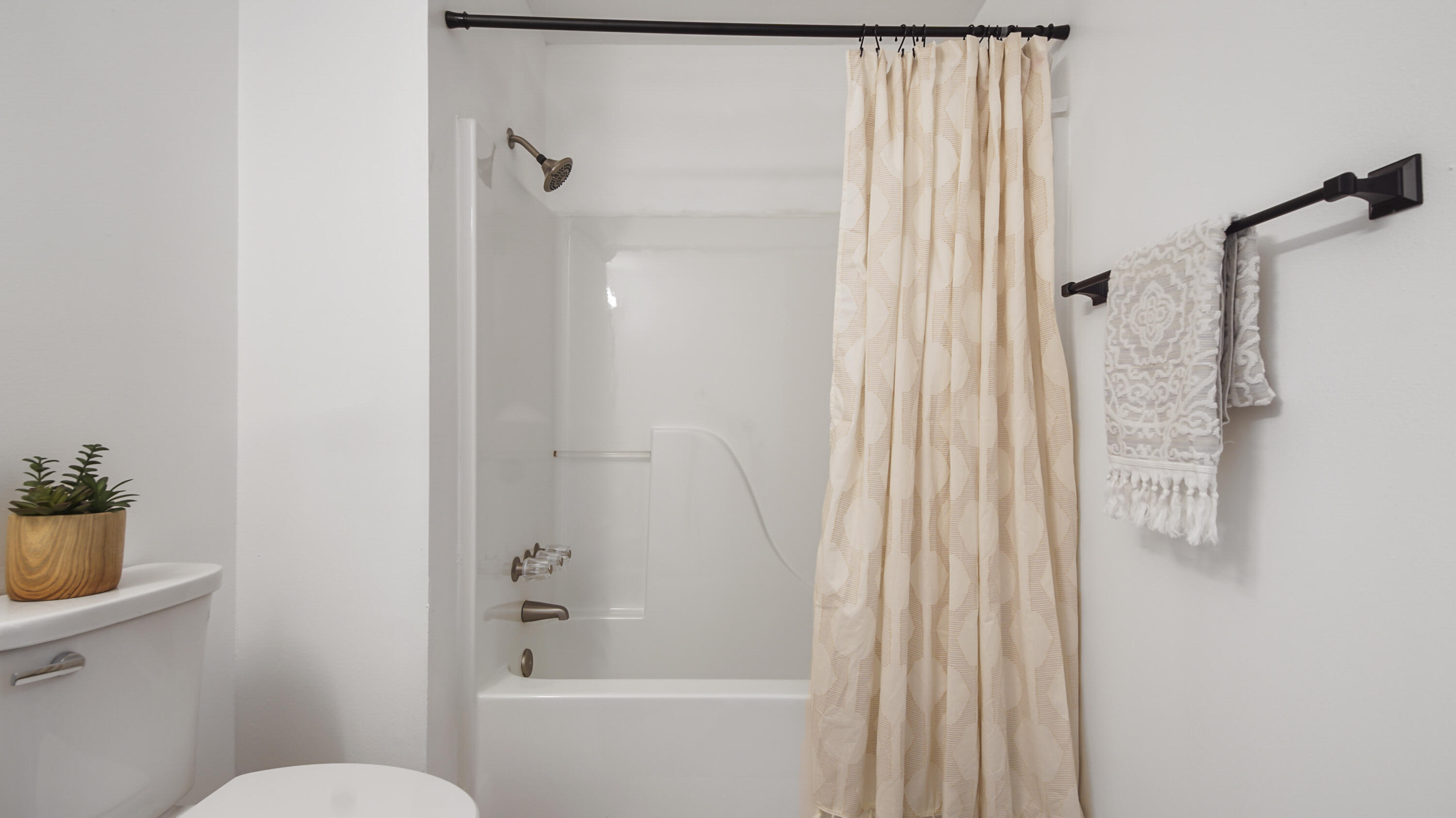 44 Ruby Circle Mary Esther, FL 32569 - Photo 21 of 34 a bathroom with a shower curtain and a toilet
