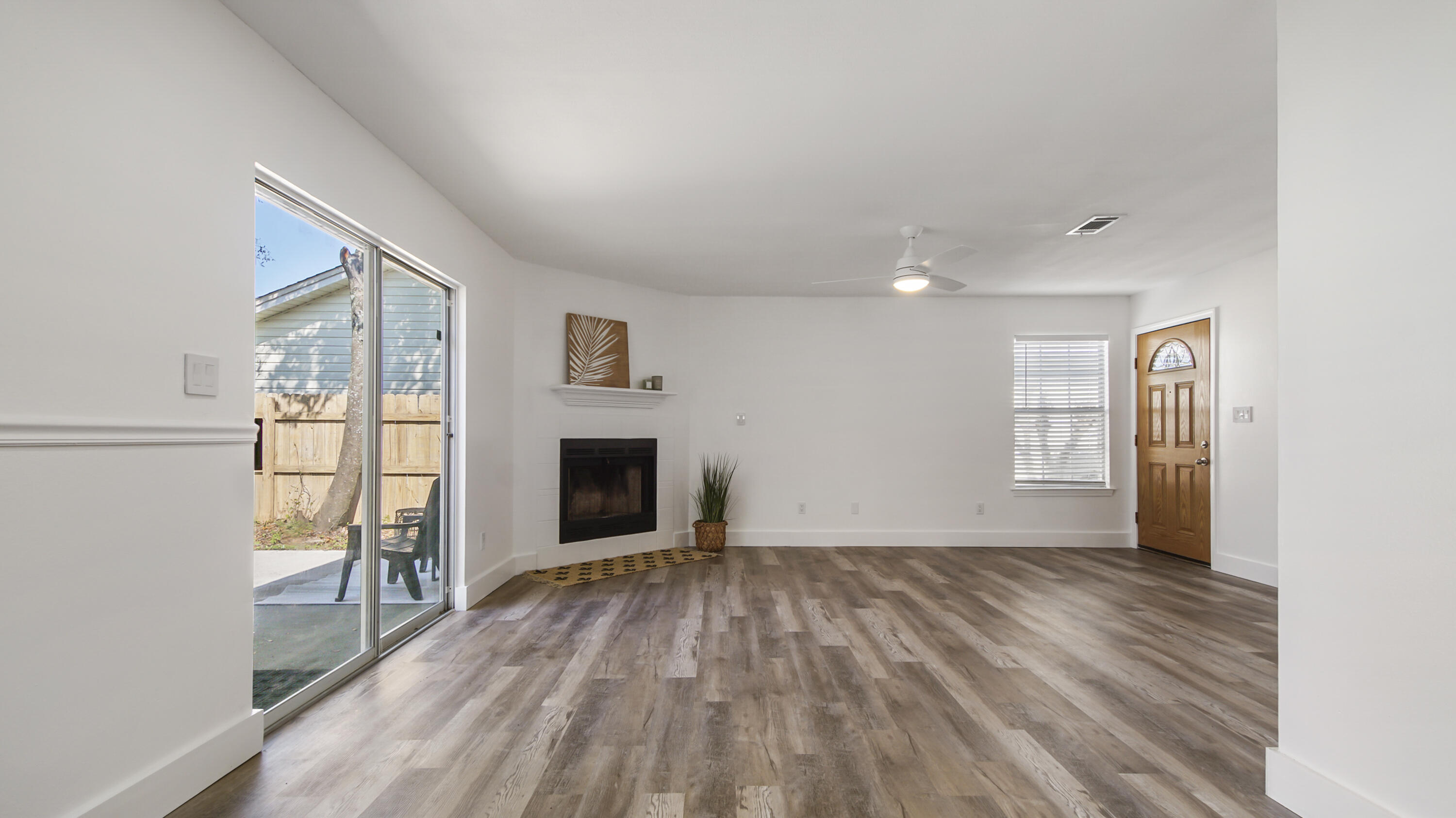 44 Ruby Circle Mary Esther, FL 32569 - Photo 5 of 34 a view of empty room with wooden floor and fireplace