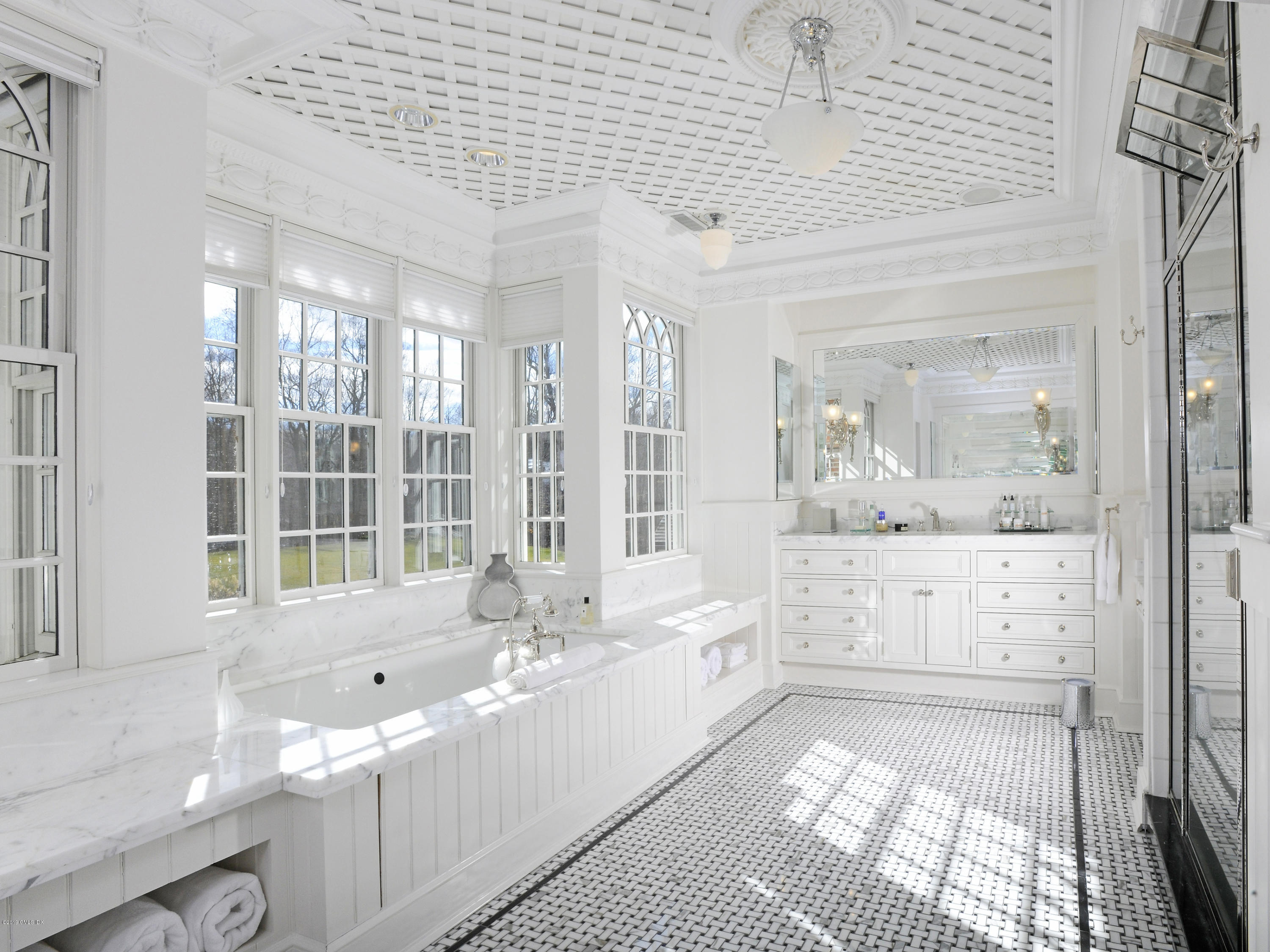 74 Upper Cross Road Greenwich, CT 06831 - Photo 13 of 21 a bathroom with a double vanity sink a large mirror and a bathtub with shower