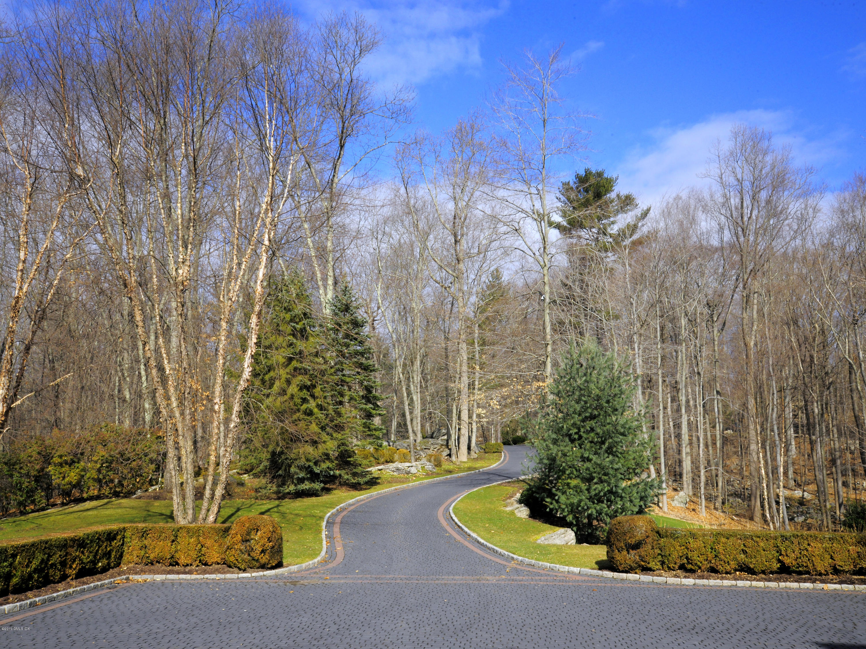 74 Upper Cross Road Greenwich, CT 06831 - Photo 15 of 21 a front view of a house with a yard