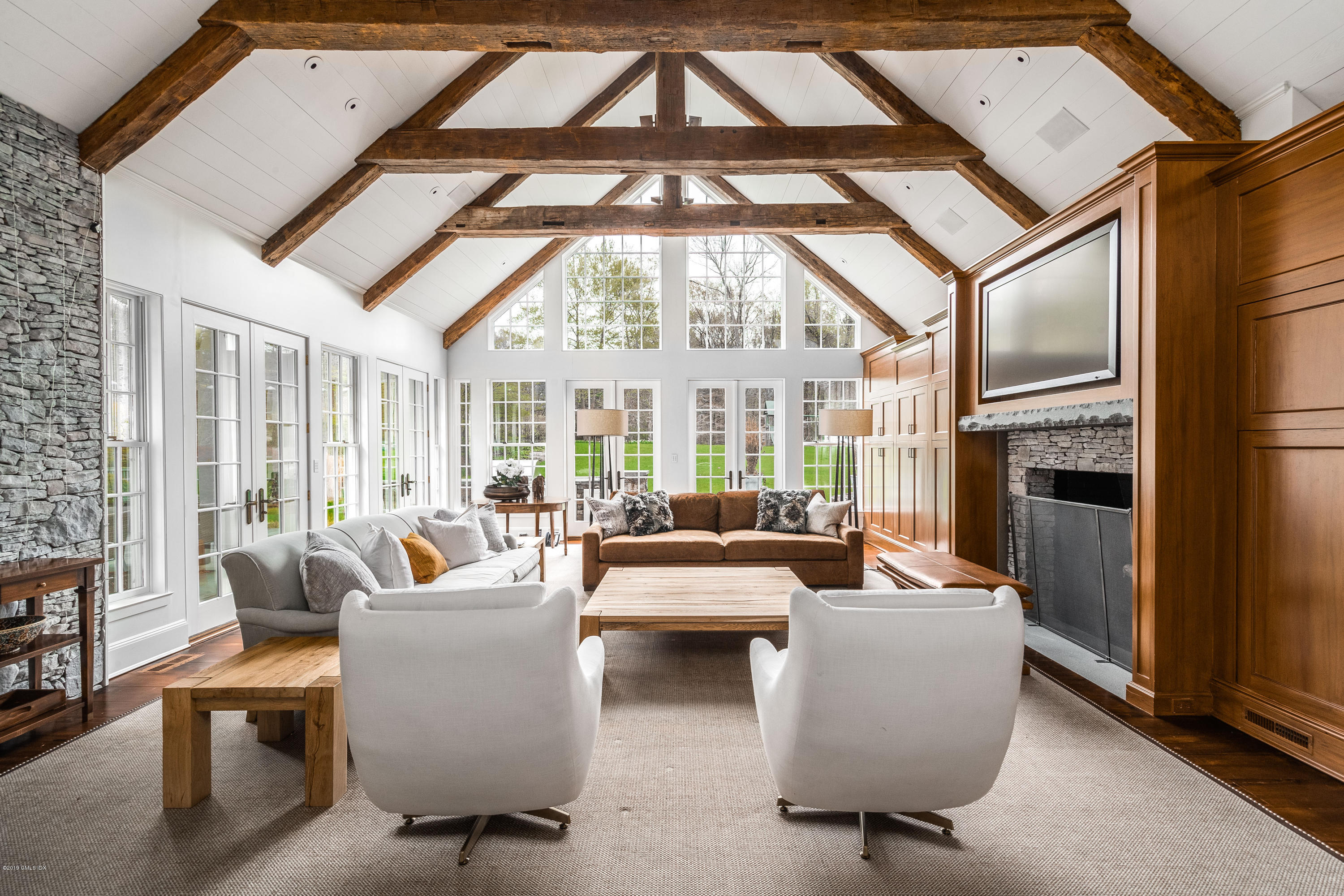 74 Upper Cross Road Greenwich, CT 06831 - Photo 19 of 21 a living room with furniture a large window and a fireplace