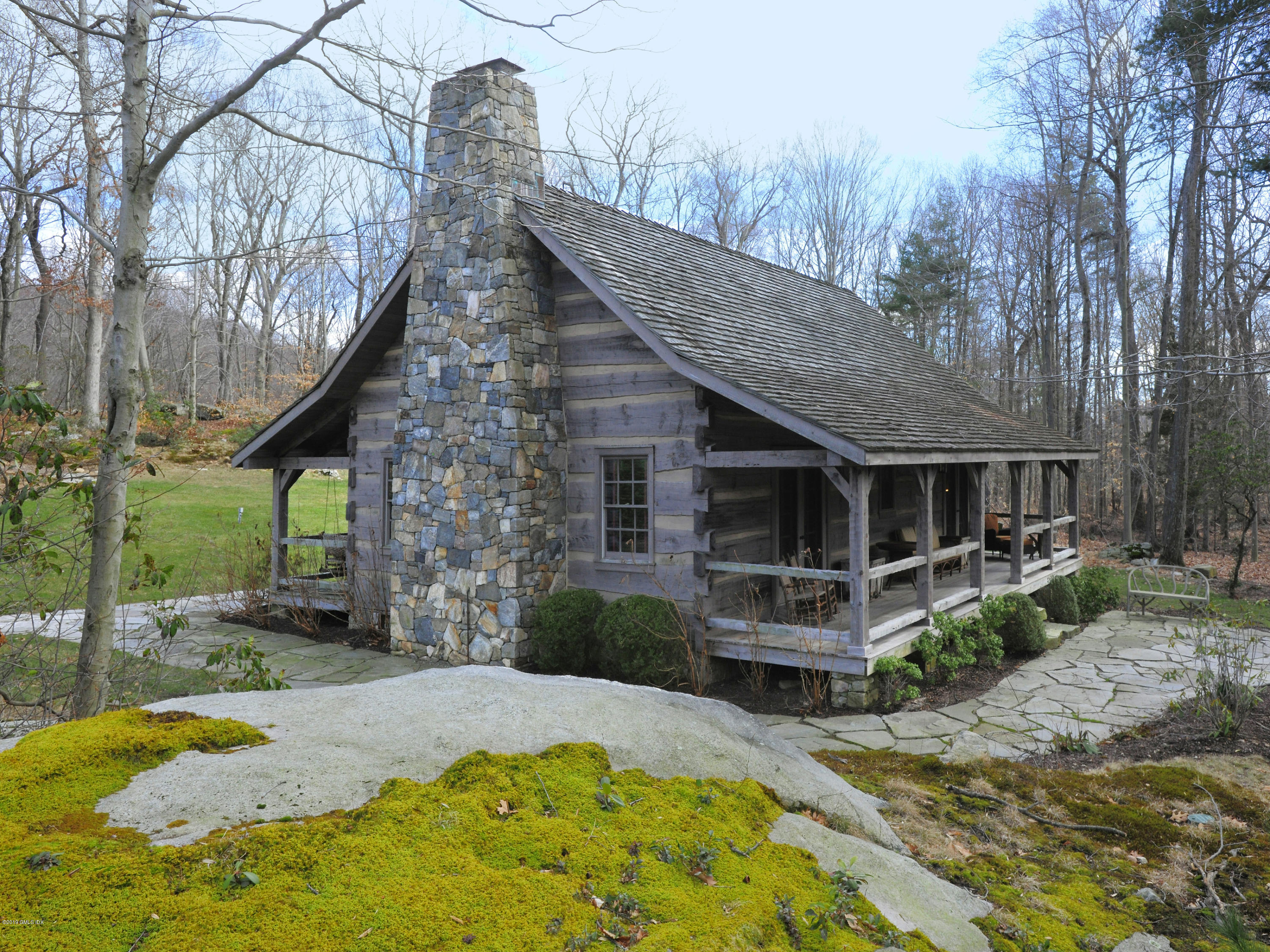 74 Upper Cross Road Greenwich, CT 06831 - Photo 20 of 21 a front view of a house with a yard