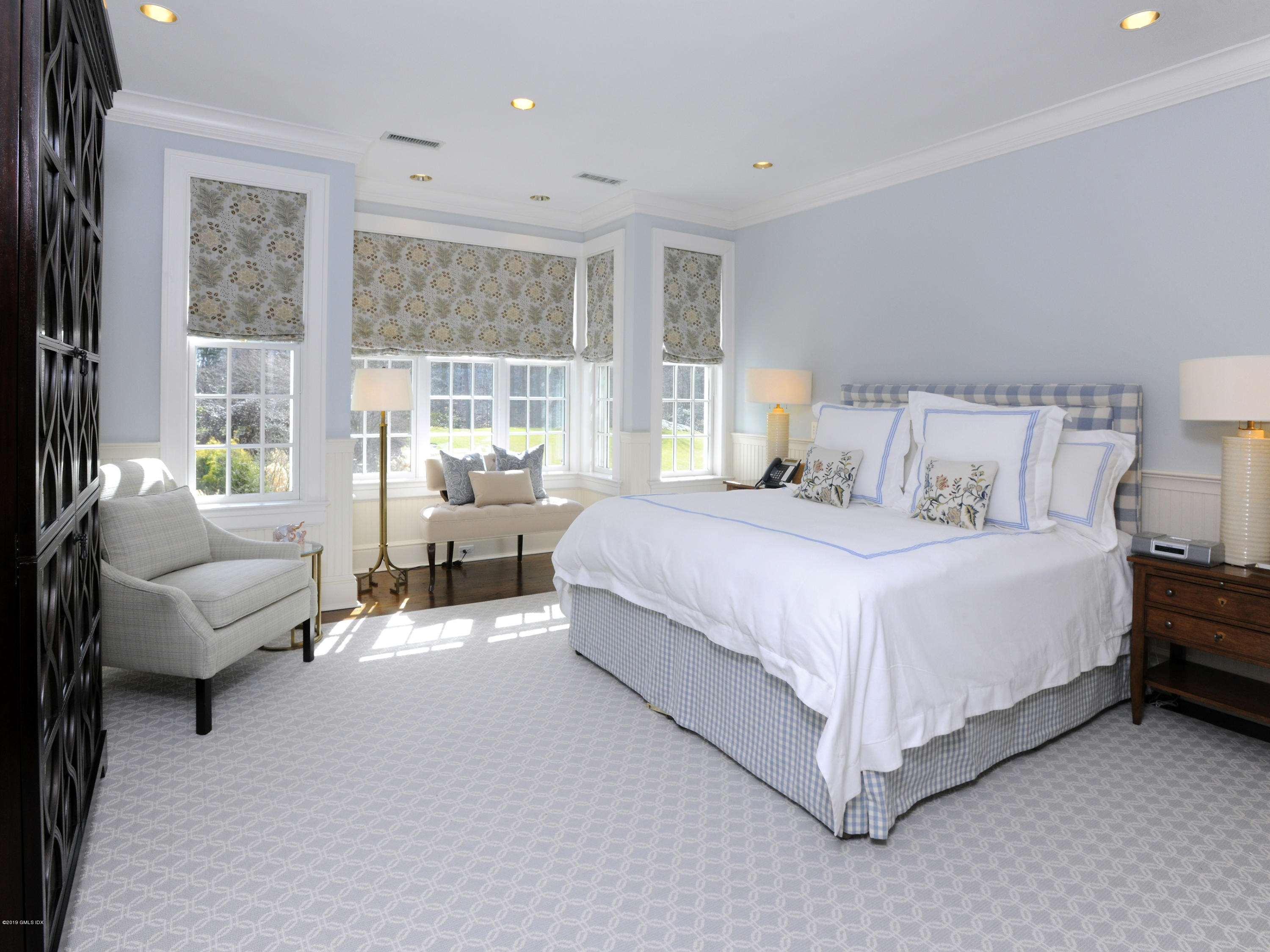 74 Upper Cross Road Greenwich, CT 06831 - Photo 21 of 21 a spacious bedroom with a bed couch and a large window