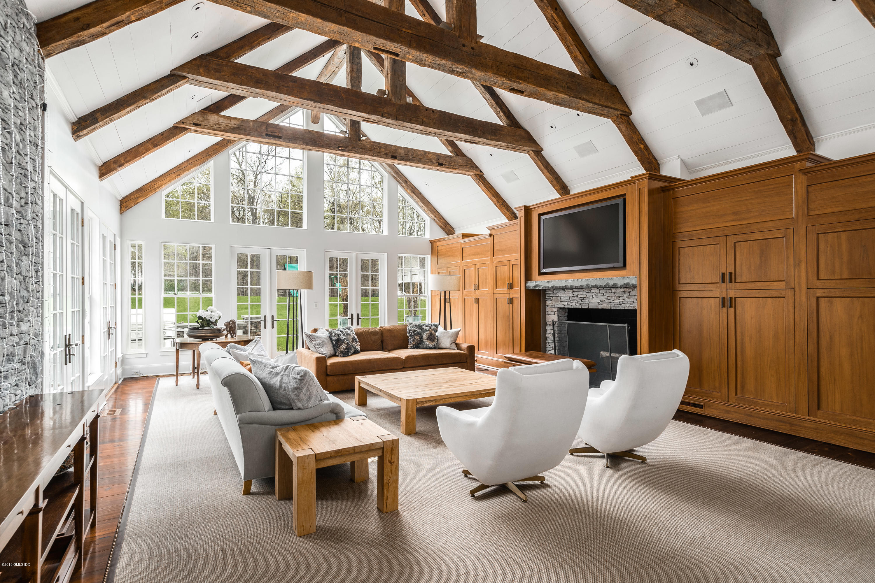 74 Upper Cross Road Greenwich, CT 06831 - Photo 6 of 21 a room with fireplace furniture and large windows