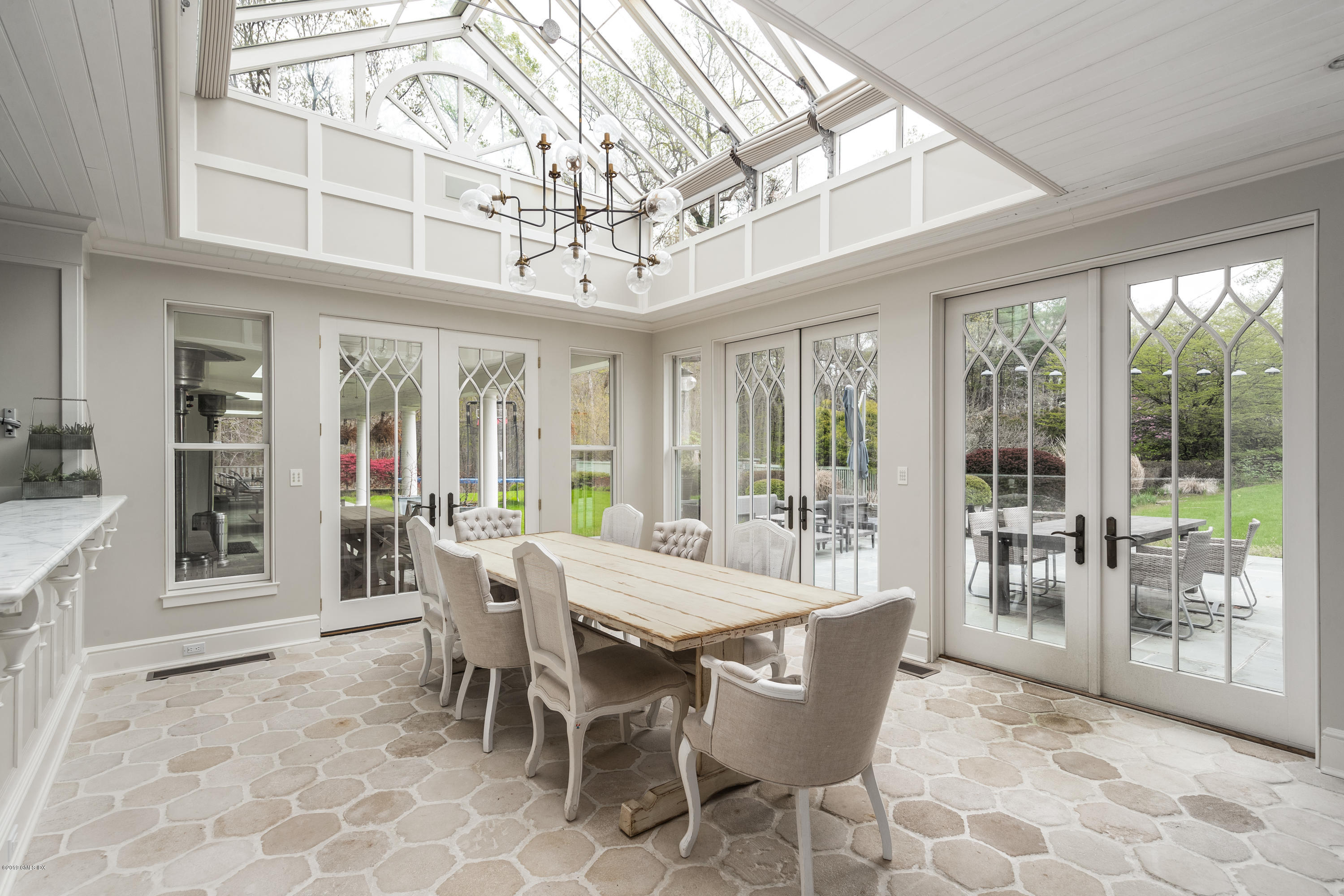 74 Upper Cross Road Greenwich, CT 06831 - Photo 7 of 21 a view of a dining room with furniture large windows and wooden floor