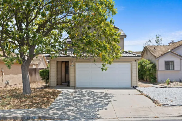 a front view of a house with trees