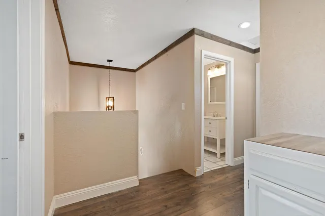 a view of hallway with wooden floor