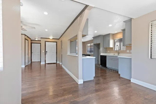 a view of kitchen with kitchen island wooden floor center island and stainless steel appliances