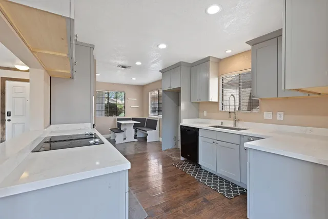 a kitchen with sink refrigerator and stove