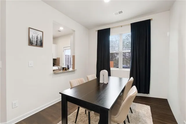 a view of a dining room with a table and chairs