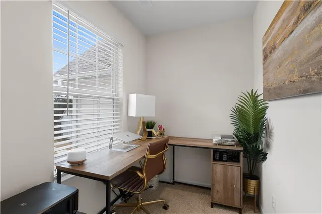 a view of a workspace with furniture