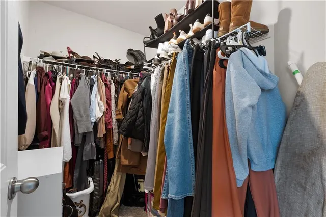 a view of walk in closet with clothes