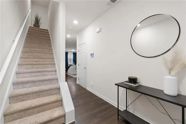 a view of entryway and hall with wooden floor