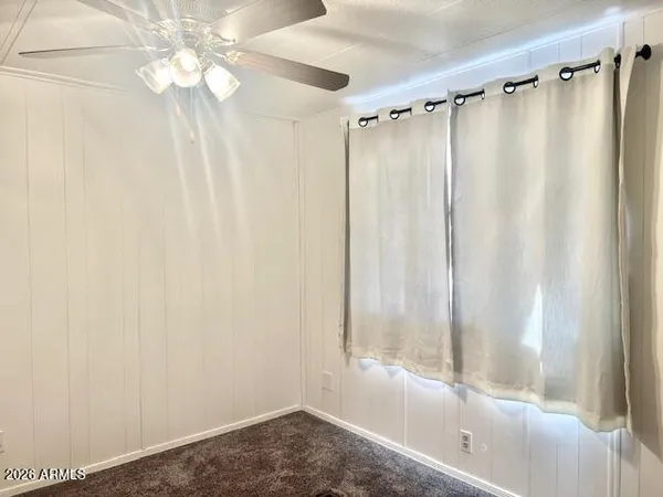 a bathroom with a shower curtain and a window