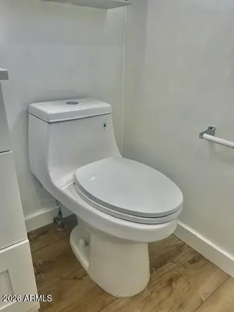a white toilet sitting next to a white toilet