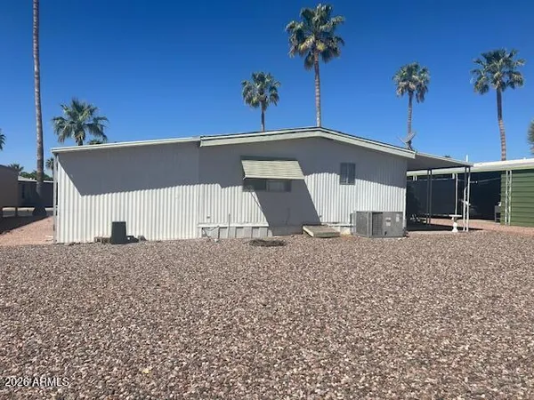 a view of a house with a yard and potted plants