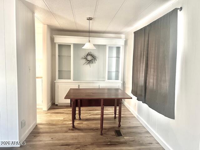 2605 South Tomahawk Road, Unit 187 Apache Junction, AZ 85119 - Photo 8 of 33 a dining room with wooden floor a glass table and chairs