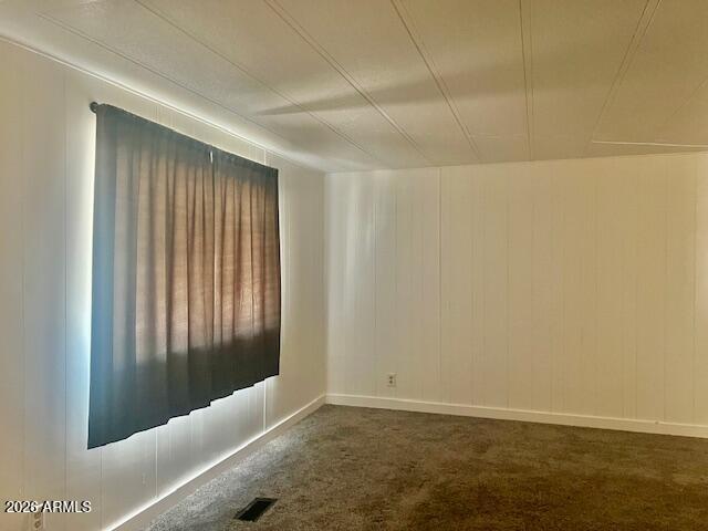 2605 South Tomahawk Road, Unit 187 Apache Junction, AZ 85119 - Photo 9 of 33 an empty room with wooden floor and windows