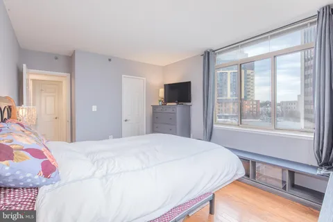a bedroom with a large bed and a window