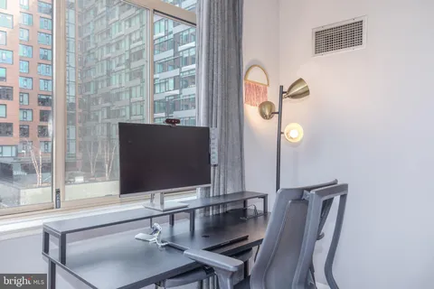 a room with a table and a flat screen tv