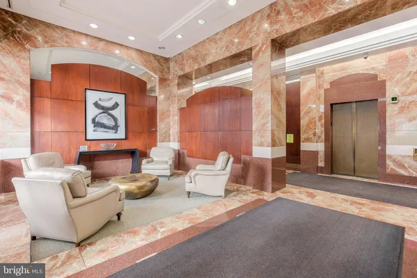 a living room with furniture and painting on the wall
