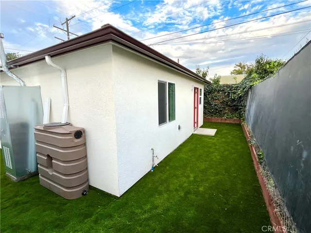 a view of a backyard with plants and a patio