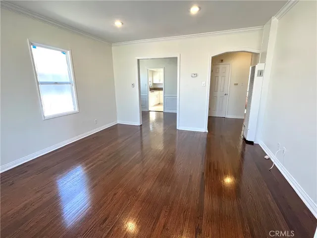 a view of a room with wooden floor and window