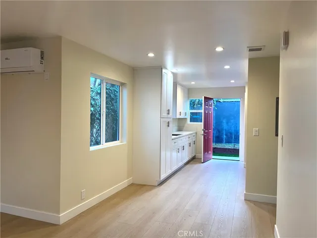 a open kitchen with windows and refrigerator