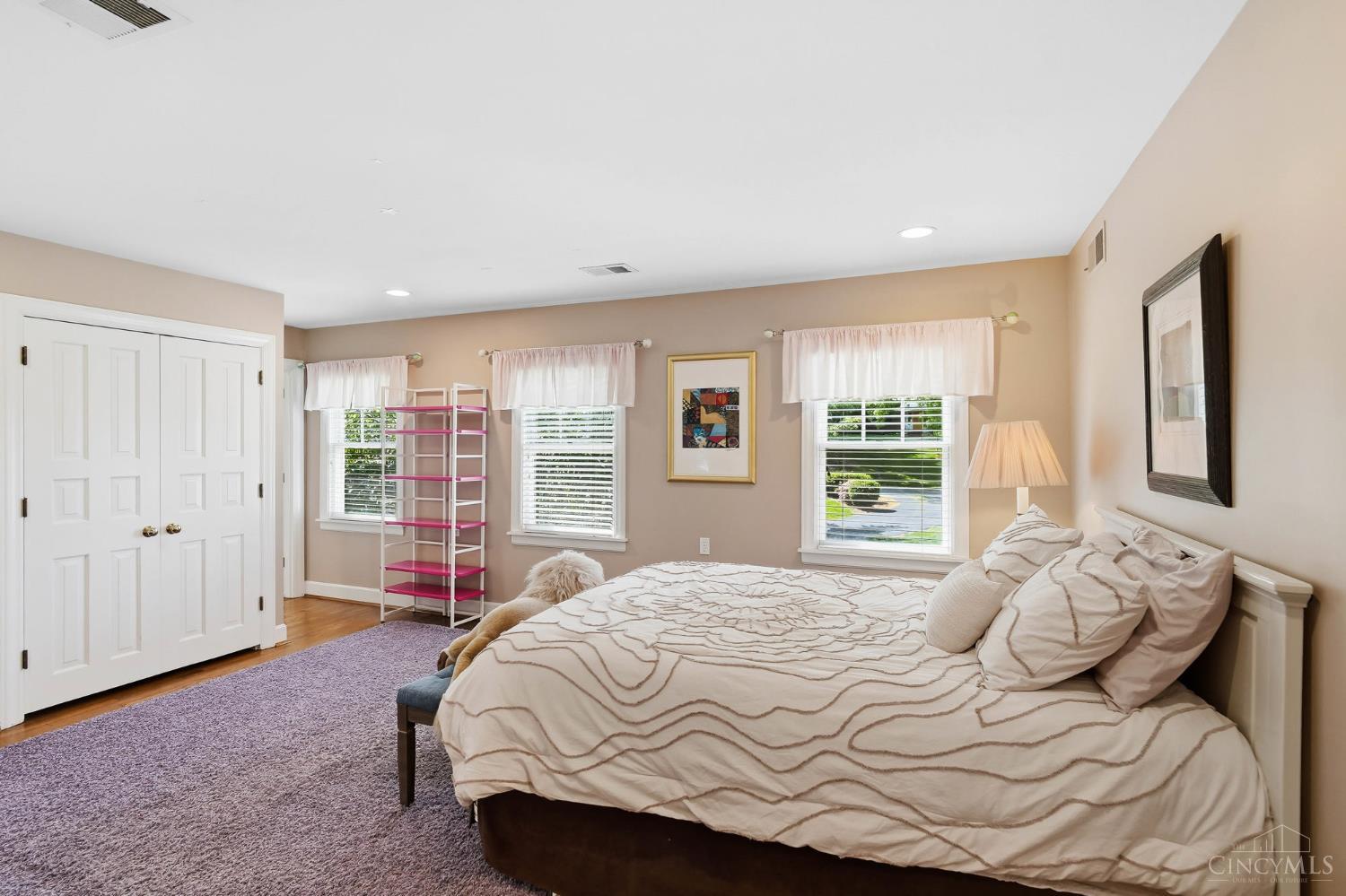 2780 Walsh Road Cincinnati, OH 45208 - Photo 38 of 68 This spacious upper-level bedroom offers a warm, inviting feel with hardwood floors, soft neutral tones, and an abundance of natural light from multiple windows. Generously sized, the room easily accommodates a full suite of furnishings and features ample closet storage for everyday ease. Its layout provides flexibility for a variety of arrangements, whether maintaining it as a serene sleeping retreat or incorporating a sitting area or workspace. Ideally positioned, the bedroom adjoins a full bath, enhancing both comfort and convenience, and creating a well-rounded, functional living space.