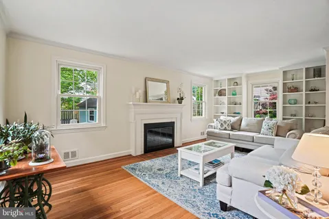 a living room with furniture fireplace and window