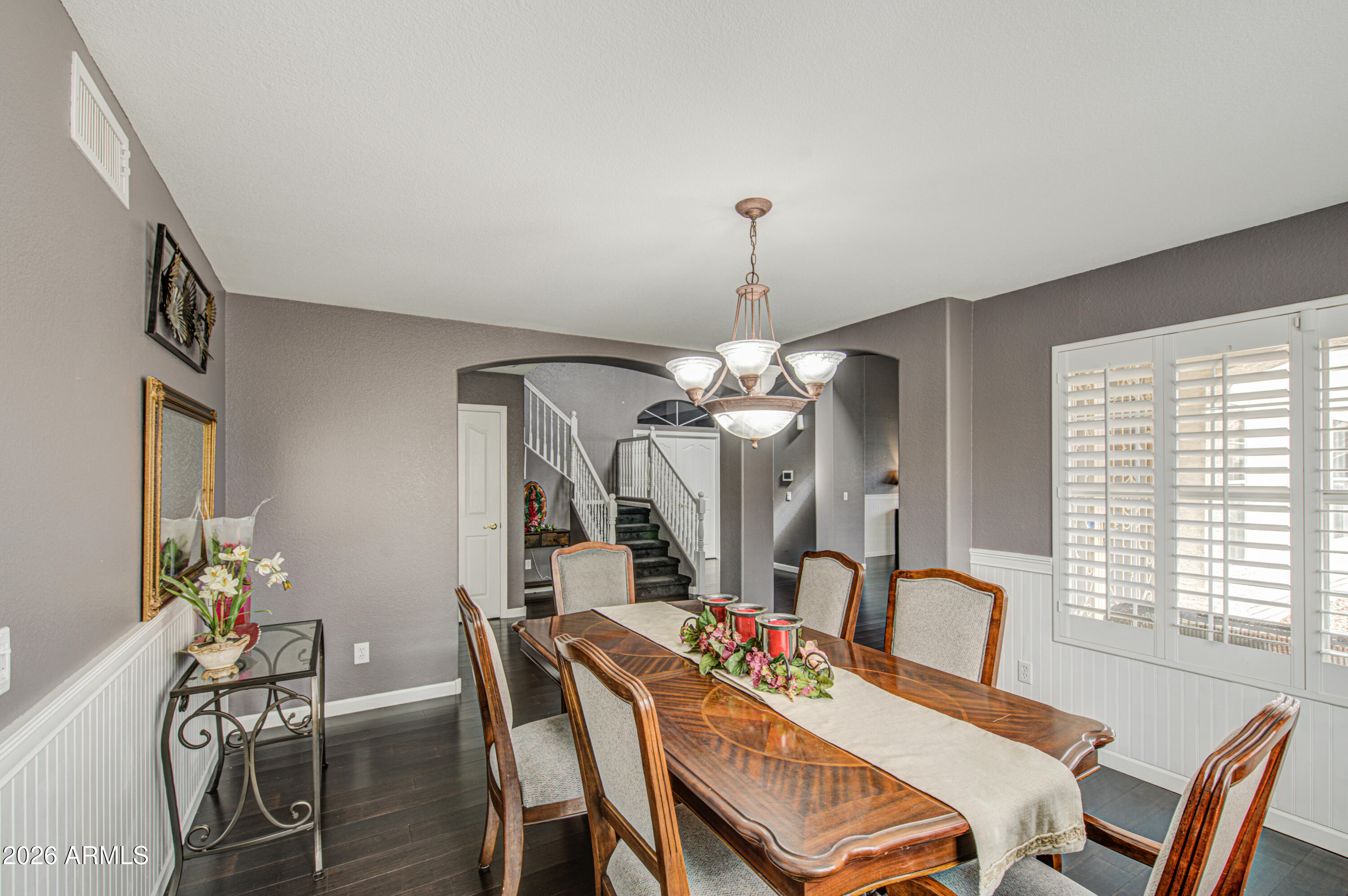 12403 West Monte Vista Road Avondale, AZ 85392 - Photo 13 of 63 a view of a dining room with furniture and chandelier