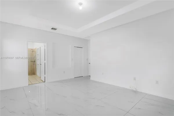 a view of an empty room with a window