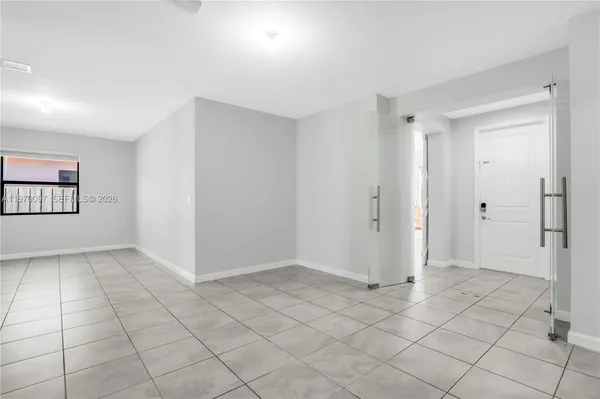 a kitchen with white cabinets and appliances