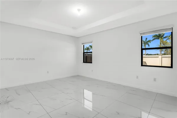 an aerial view of houses with swimming pool