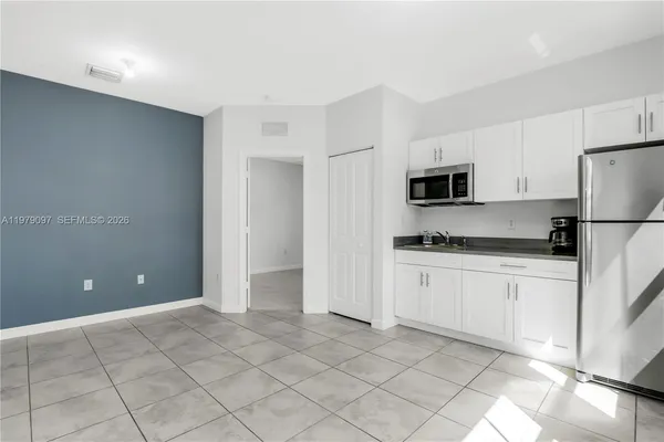an aerial view of residential houses with outdoor space and swimming pool