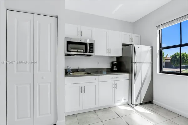 an aerial view of a house with a lake