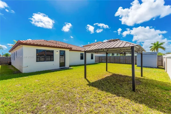 an aerial view of a residential houses with outdoor space