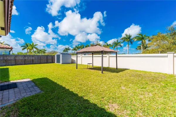 a view of a house with a yard and sitting area