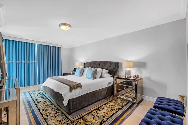 a bedroom with a bed and a dresser with wooden floor