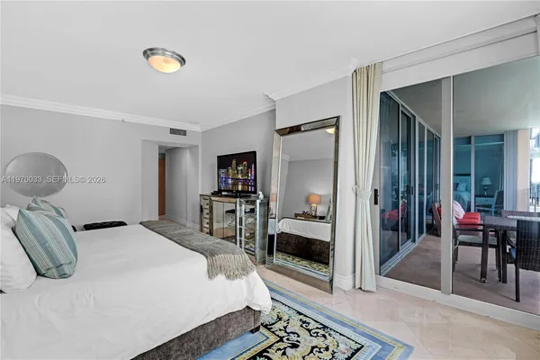 a bedroom with a bed and a view of bathroom