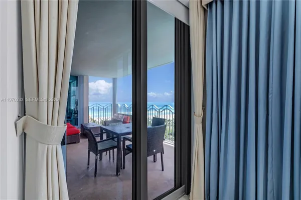 a view of a dining room with furniture and a window