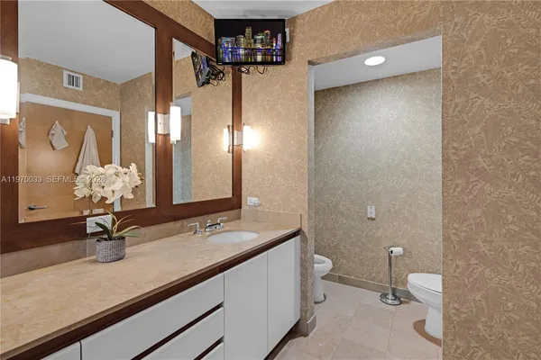 a bathroom with a double vanity sink and a mirror