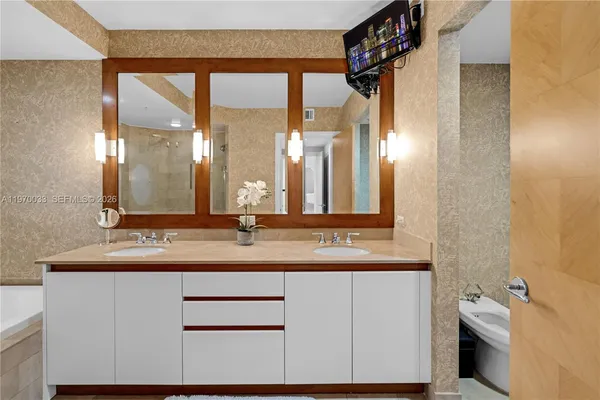 a bathroom with a double vanity sink and a mirror