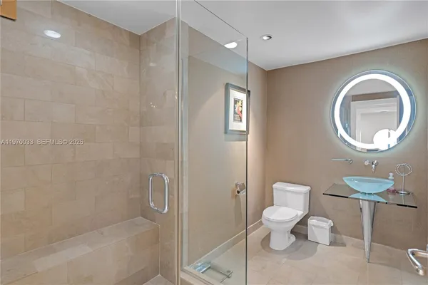 a bathroom with a toilet sink and shower