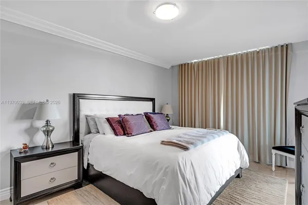 a bedroom with a bed and a night stand